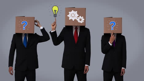 Team-of-businessman-hiding-head-with-box-and-gesturing