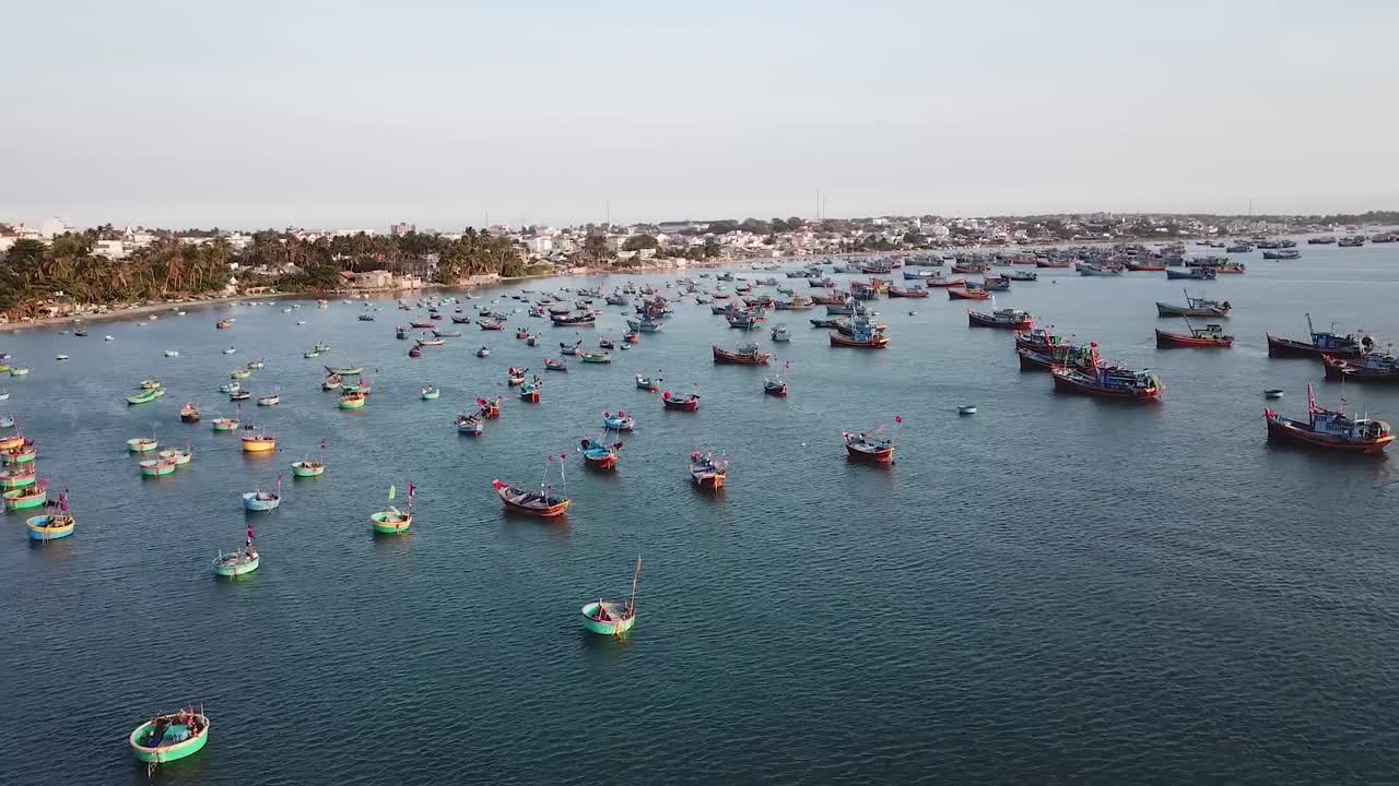 rising shot to the right discovering a bay full with traditional fisherman boats