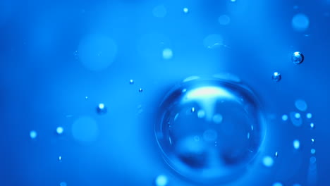 blue abstract gas bubbles rising in liquid