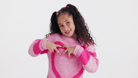 girl making a heart shape with her hands