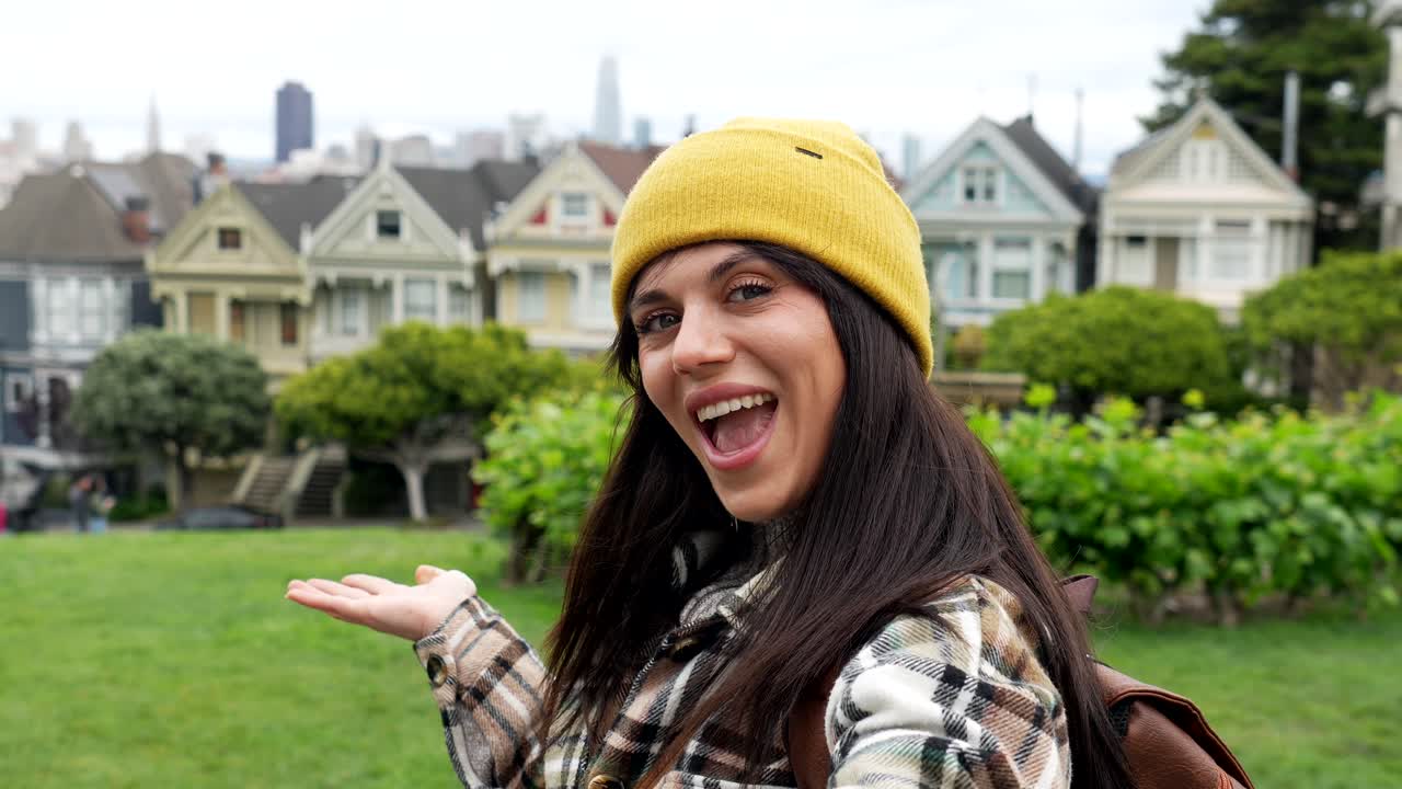 Giovane donna felice in posa davanti alle Painted Ladies a San Francisco