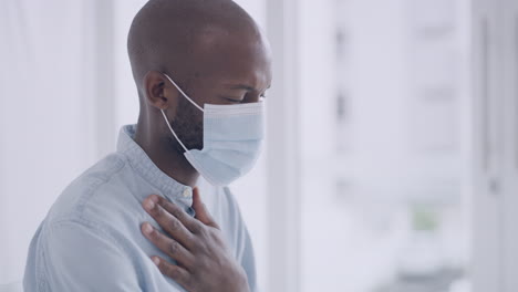 man suffering from illness wearing a mask