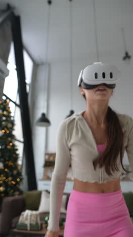 woman using vr headset for fitness in a home with christmas tree