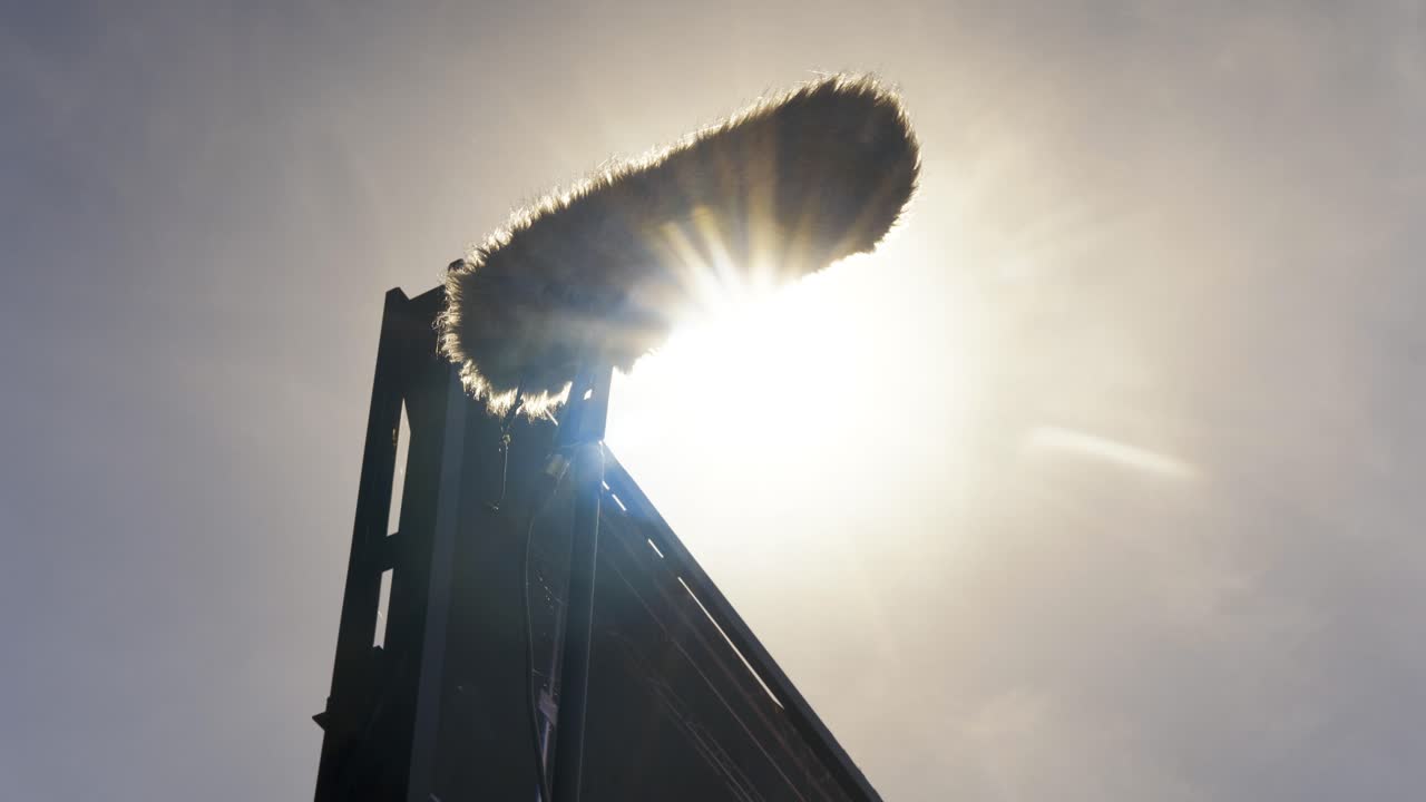 A silhouetted microphone against a warm sunset, perfect for podcasting, music production, and media projects, capturing a cinematic golden hour recording with a creative touch.
