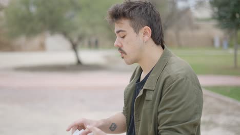 man performing magic trick in a park