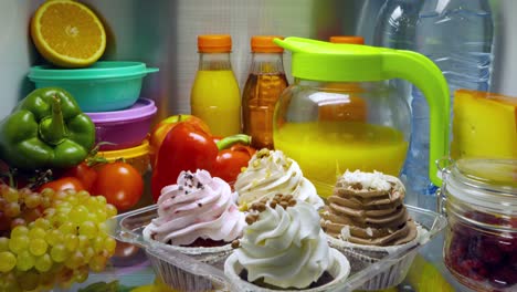 sweet cakes in the open refrigerator.