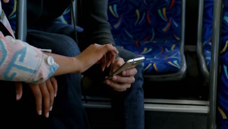 couple using mobile phone while travelling in bus 4k