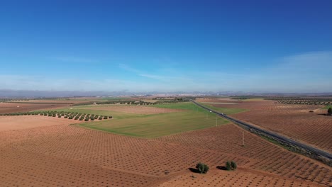 landscape of crop field with road with vehicles from drone view