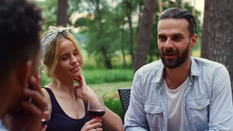 focused man chatting with friends on backyard. man telling story outdoors
