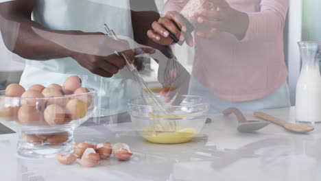 A-young-African-American-couple-enjoys-breakfast-together-at-home-in-the-kitchen