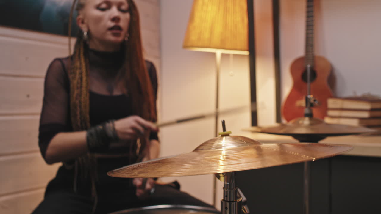 Rock-and-Roll Woman Playing Drums In Studio