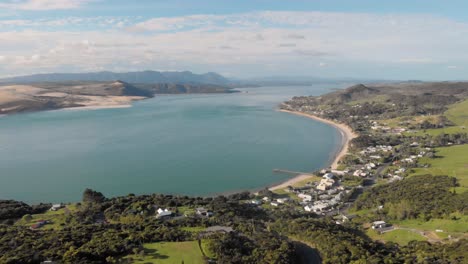 aerial drone flying sideways away from omapere, new zealand