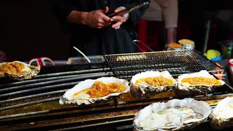 oysters being prepared at a street food stall