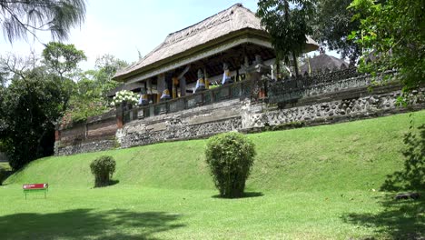 pura taman ayun, taman ayun temple,bali indonesia, the panoramic view in sunny day,on the plate an inscription in indonesian "on a lawn not to go"