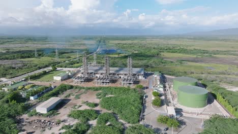 Aerial-orbiting-shot-of-electrical-substation-with-rising-fumes-in-Wilderness-of-Dominican-Republic