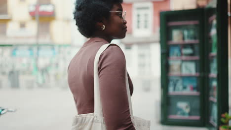 dark-skinned girl is standing outdoors