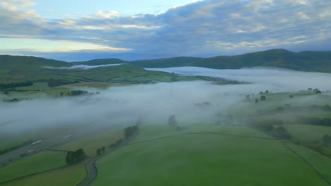 English-countryside-at-sunrise-with-M6-motorway,-misty-landscape-and-fog-in-valley-at-sunrise