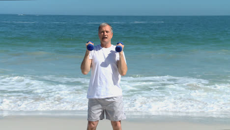 Elderly-man-working-his-muscles-with-dumbbells