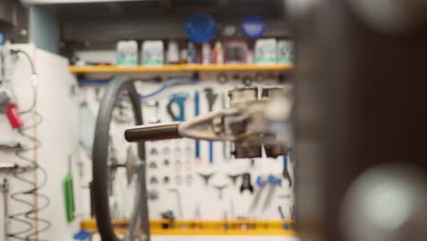 mechanic centering bike wheel on truing stand
