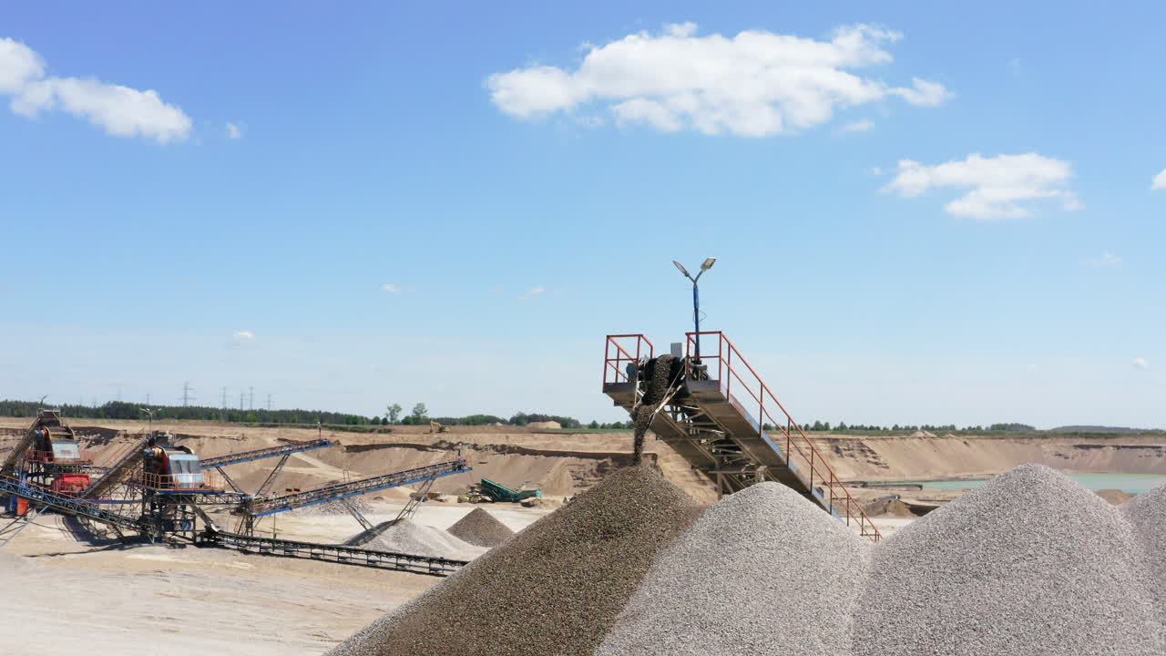 Closeup Of Conveyor Belt At Work At Gravel Processing Plant In Quarry Site. orbiting drone shot