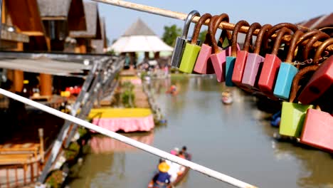 pattaya floating market. tourist wooden boat moving along the water. thailand, asia