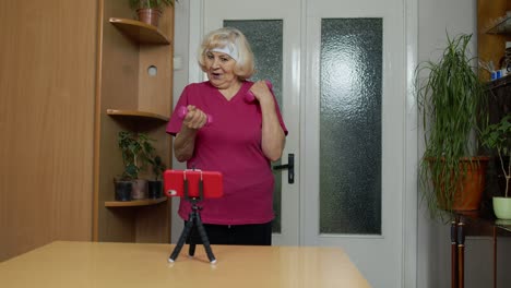 Old-senior-grandmother-woman-doing-workout-with-dumbbells,-training,-fitness,-sport-activity-at-home