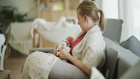 mother holding newborn baby wrapped in blanket