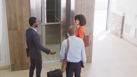 happy diverse business people taking elevator at office, slow motion