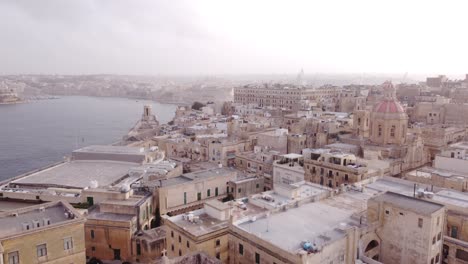 drone correcting high altitude flight over the old town of valletta malta