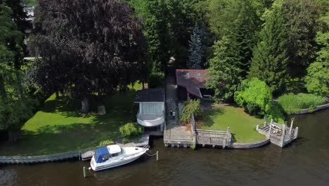 Fantastic-aerial-drone-flight-slowly-sinking-down-drone-shot-over-a-river-with-boats-and-jetty