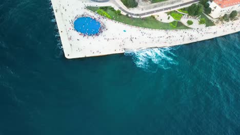 Aerial-of-Zadar-Sunset-Monument-Sea-Coast,-also-known-as-the-Monument-to-the-Sun,-is-a-captivating-and-innovative-art-installation-located-in-the-beautiful-Croatian-city-of-Zadar