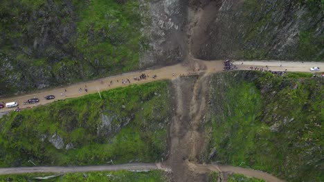 Aerial-view-of-landslide-blocking-a-highway-through-steep-hills-in-Lima,-Peru