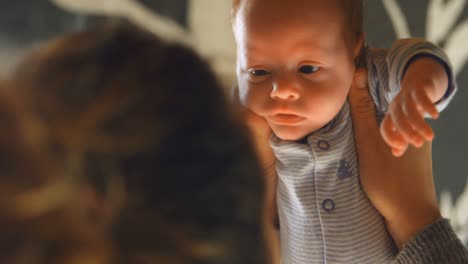 Mother-holding-her-baby-boy-at-home-4k