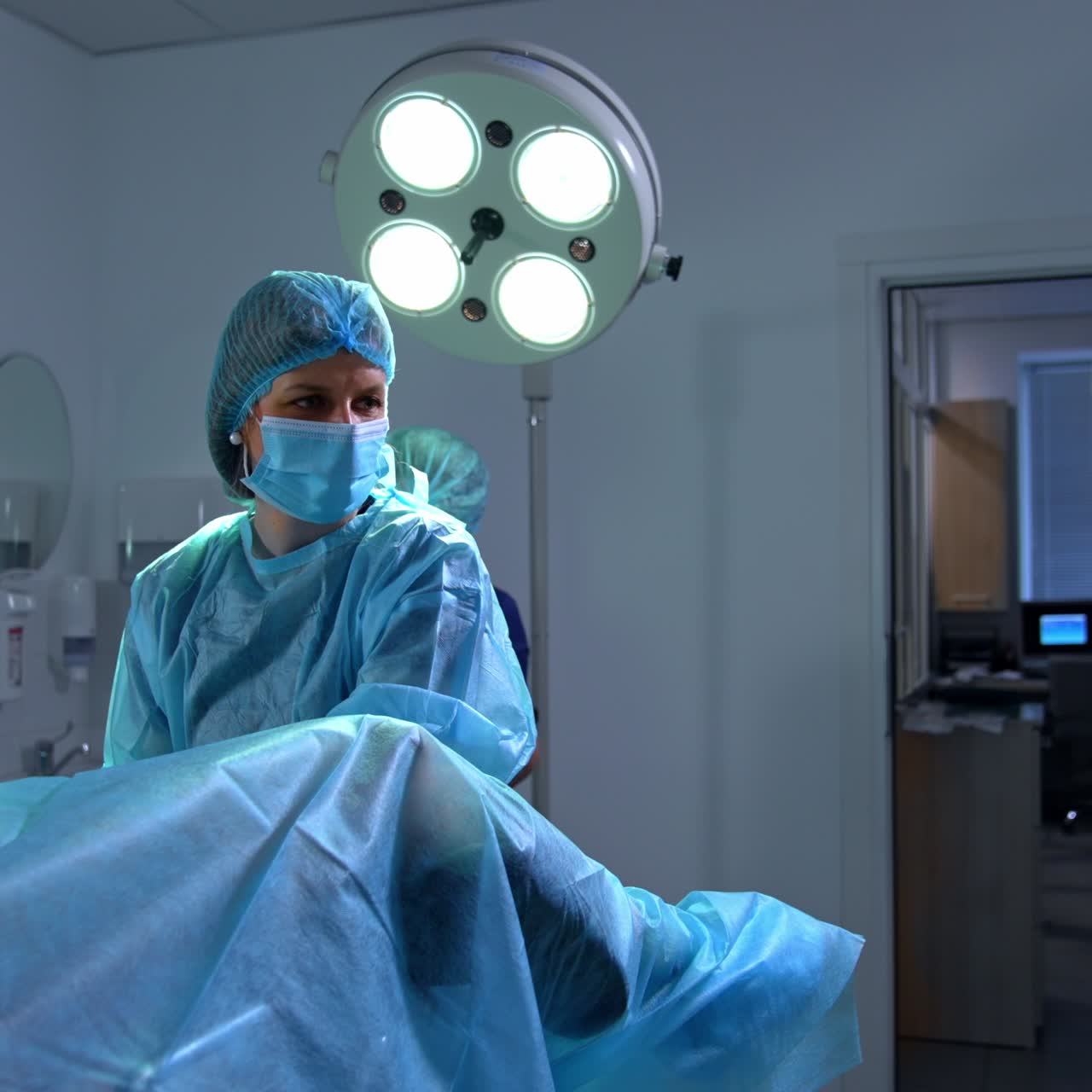 Female doctor examining the patient in her cabinet. Professional looks at the screen of ultrasound checking the inner organs condition