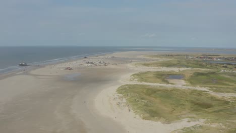 Cinematic-drone---aerial-panorama-circling-shot-of-the-sandy-beach-with-tourists-and-people-in-St