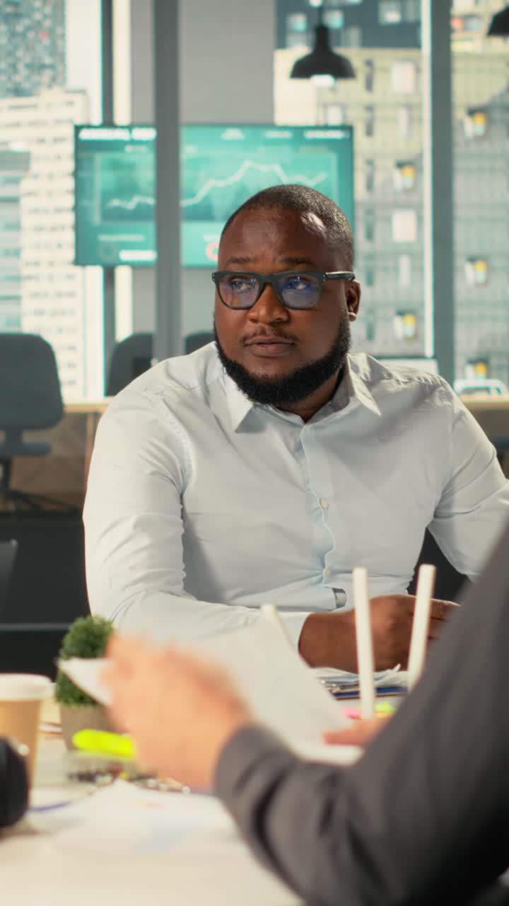Vertical Video Colleagues and employees exchanging ideas during a business meeting