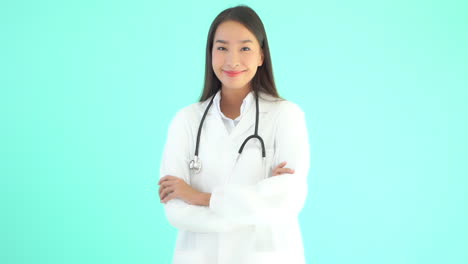 female asian doctor standing up with arms crossed and smiling