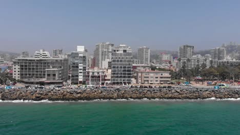 Panning-ocean-aerial-of-Valparaiso,-Chile-Colombia-Plaza-waterfront