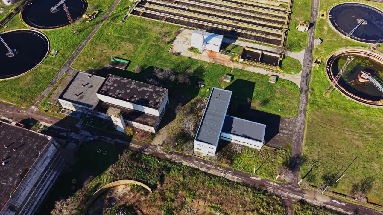Abandoned facility showing storage tanks and circular water treatment areas