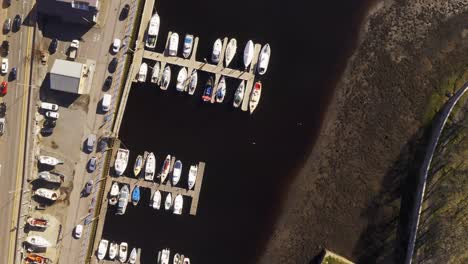 Drone-birds-eye-view-of-Stornoway,-Harbour-on-a-sunny-day-on-the-Isle-of-Lewis,-Outer-Hebrides-of-Scotland,-United-Kingdom