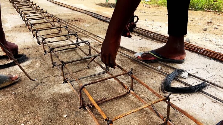 hand of construction worker with fabricating steel reinforcement bar,Workers are using steel wire to bind steel bars