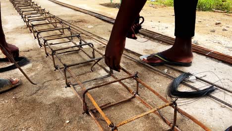 hand of construction worker with fabricating steel reinforcement bar,workers are using steel wire to bind steel bars