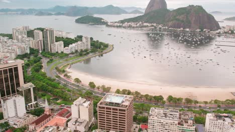 aerial orbit of botafogo beach in rio de janeiro brazil with the sugarloaf and many parked yachts, curve along the beach