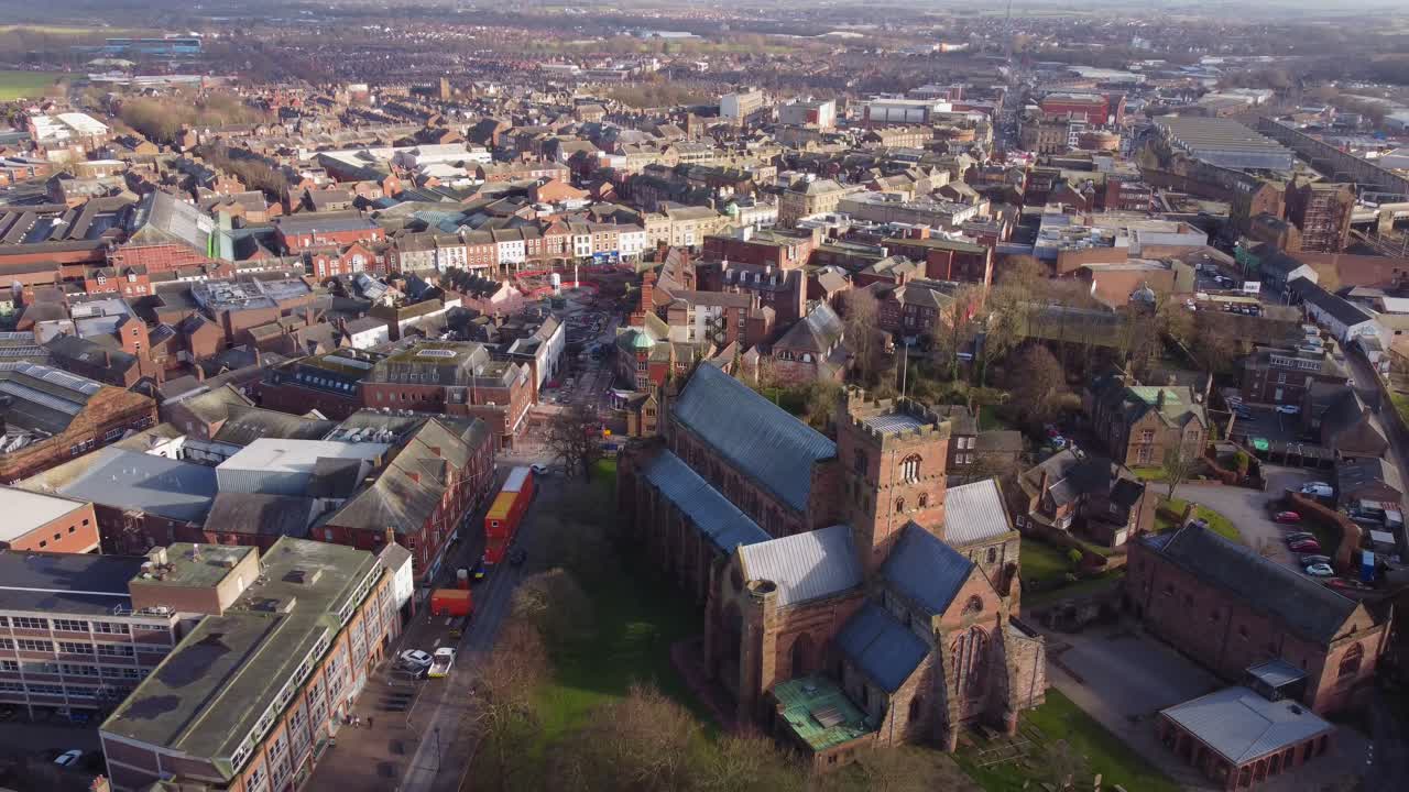 Drone revealing aerial view of Carlisle Cathedral with Carlisle City Centre - England