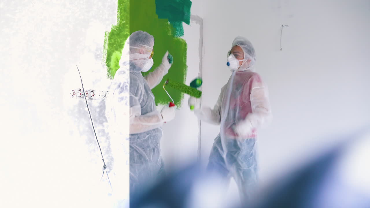 보호복을 입은 긍정적 인 가족은 방의 벽 근처에서 춤을  ⁇ 니다.