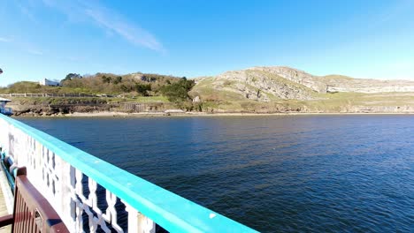 timelapse red fishing boat floating around colourful landmark great orme north wales island seascape viewpoint from promenade