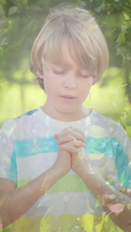 animation of caucasian boy praying over green trees in background