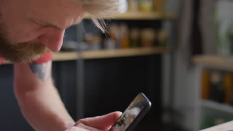 food blogger photographing dish with smartphone