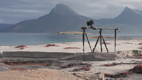 a slider rig stands on the sandy shore of the fjord