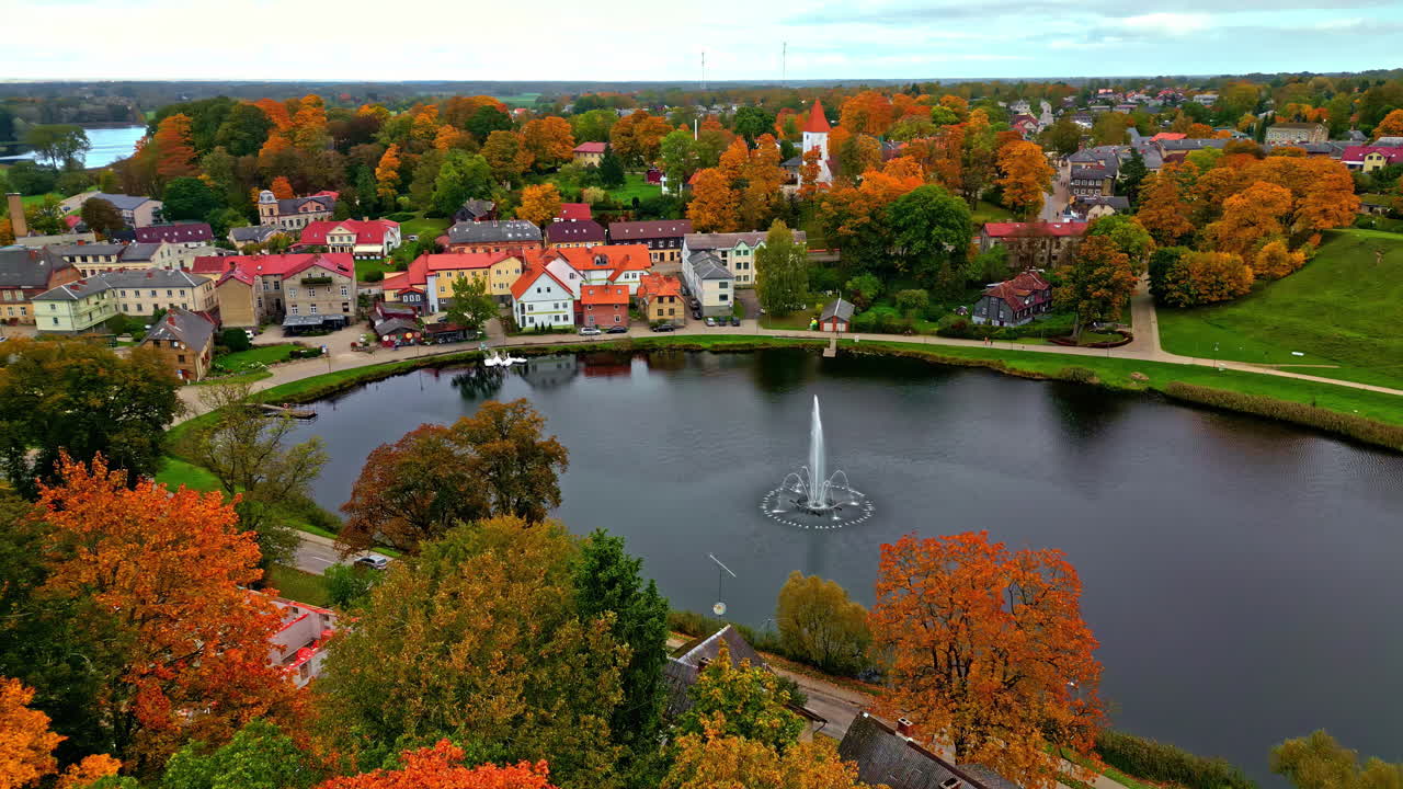 Talsi Lake Surrounded by Vibrant Autumn Foliage in a Picturesque Latvian Town